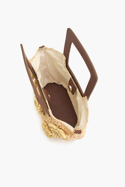 Open view of the Raffia Top-Handle Tote showing the beige lining, magnetic closure, square handle, and chain strap.