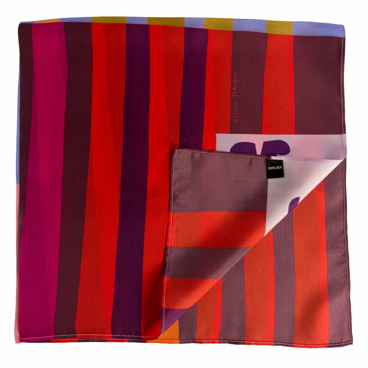 Folded Red Colorblock silk scarf showing deep red, orange, pink, and burgundy stripes with Voyager Silk tag detail.