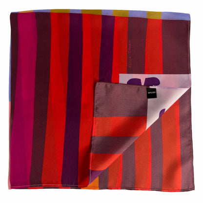 Folded Red Colorblock silk scarf showing deep red, orange, pink, and burgundy stripes with Voyager Silk tag detail.