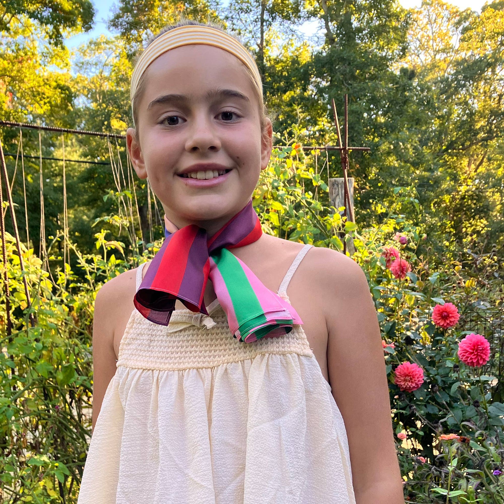 Model wearing the Red Colorblock silk scarf tied at the neck for a bright, polished everyday styling look.