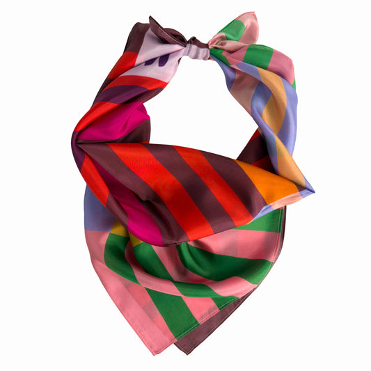 Red Colorblock silk scarf tied bandana style, showing warm red stripes, green accents, and pastel colorblocking.