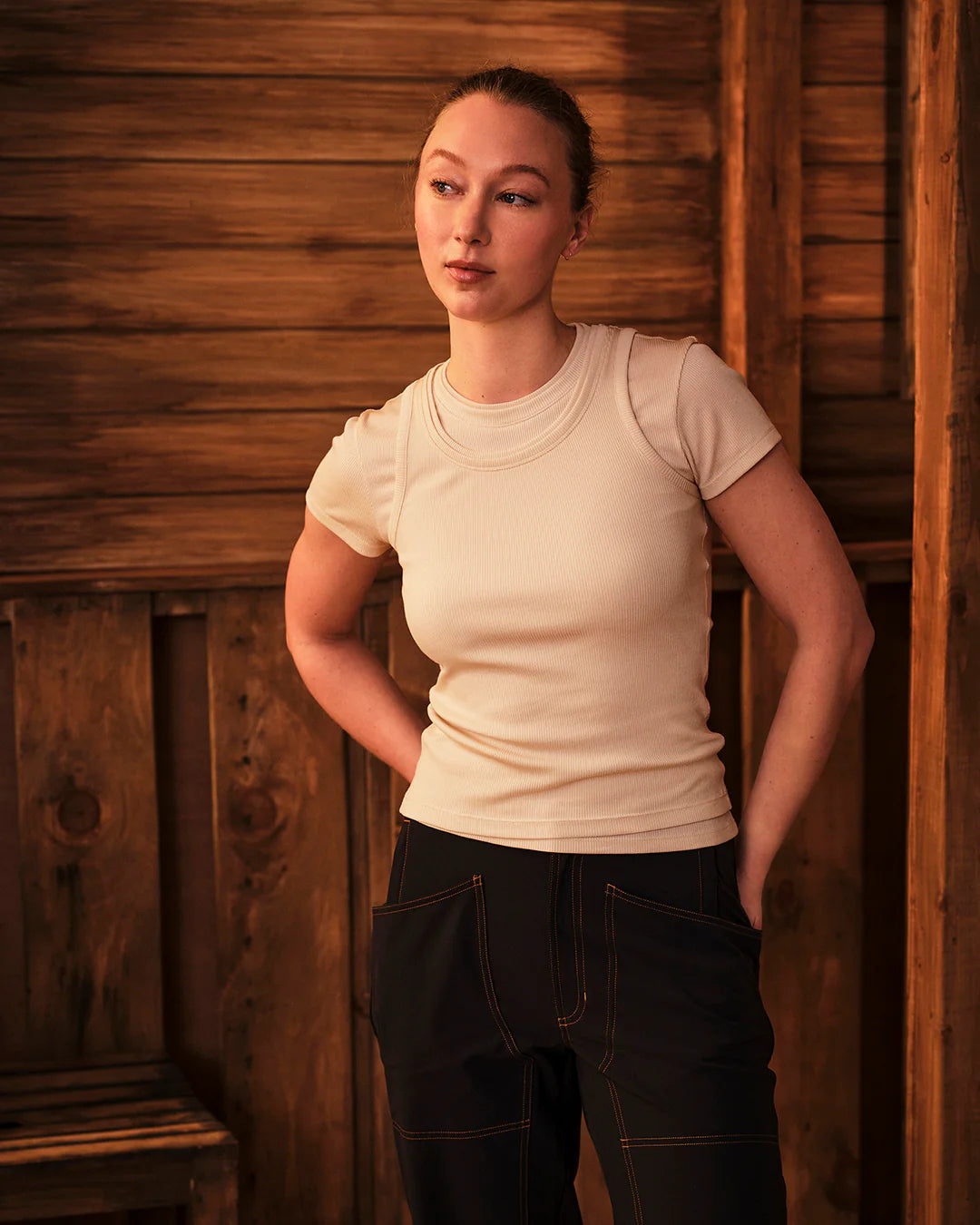 Model wearing Ribbed Merino T-Shirt in warm outdoor setting paired with utility pants