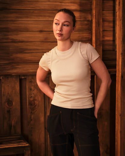 Model wearing Ribbed Merino T-Shirt in warm outdoor setting paired with utility pants