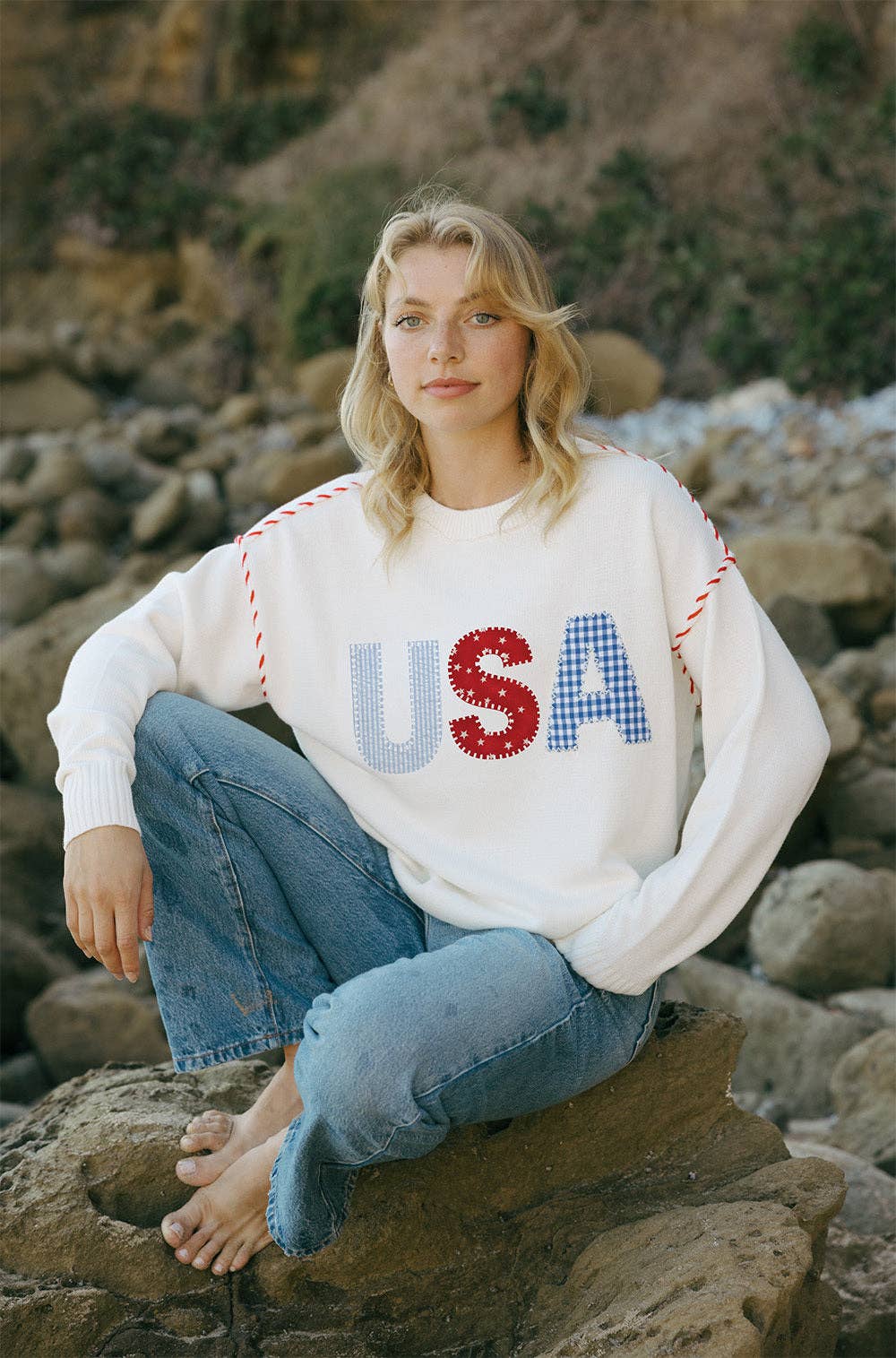 Model wearing the Riley Crew USA Patchwork in Ivory with relaxed denim, showing the oversized fit and patchwork USA front detail.
