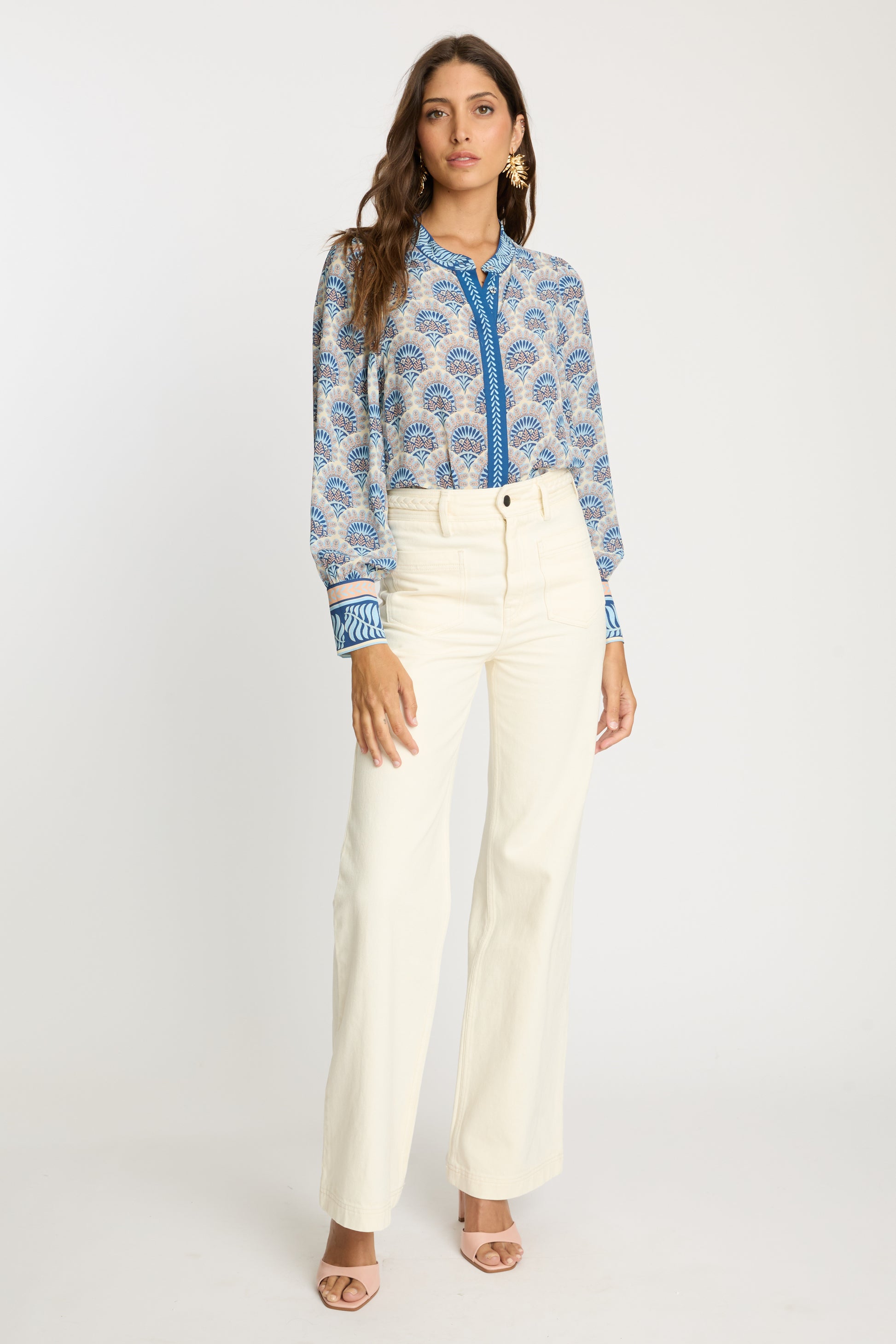 Full-length front view of the Riley Top in Boho Deco styled with cream wide-leg pants, featuring a mandarin collar, blue embroidered placket, long gathered sleeves, and soft geometric bohemian print.