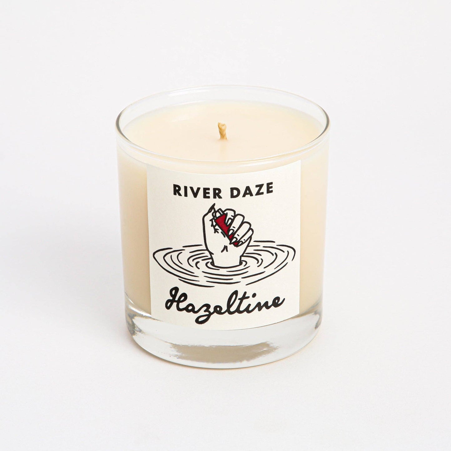 Front view of River Daze scented candle in a clear glass jar with Hazeltine label.