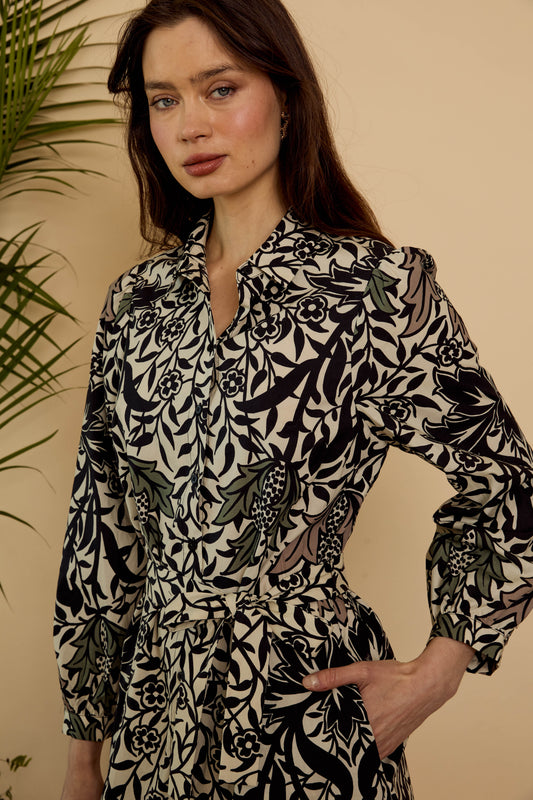 Close-up of the Roan Dress in Safari Garden Morning showing the pointed collar, button-front bodice, botanical print, and self-tie waist