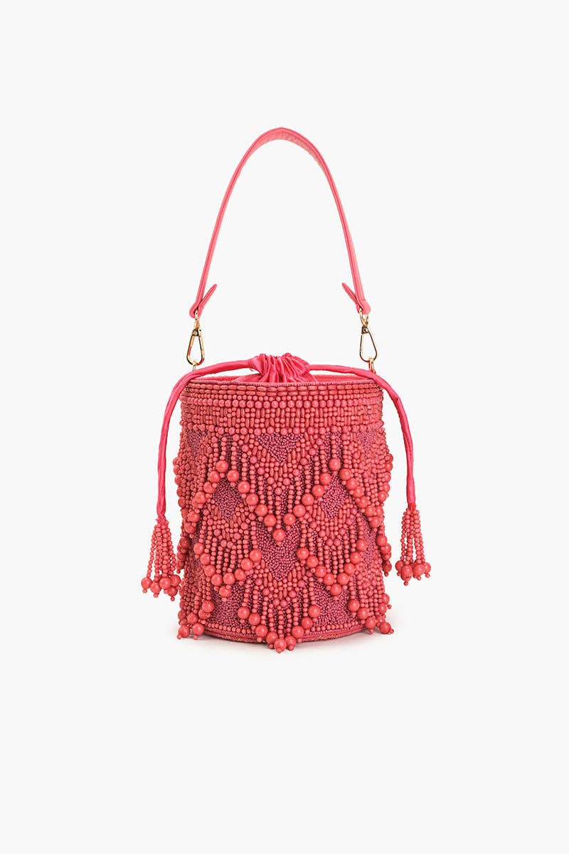 Rose Eden Bucket Bag with all-over rose quartz beaded fringe, pink wrist-carry handle, tassel details, and gold-finish hardware.