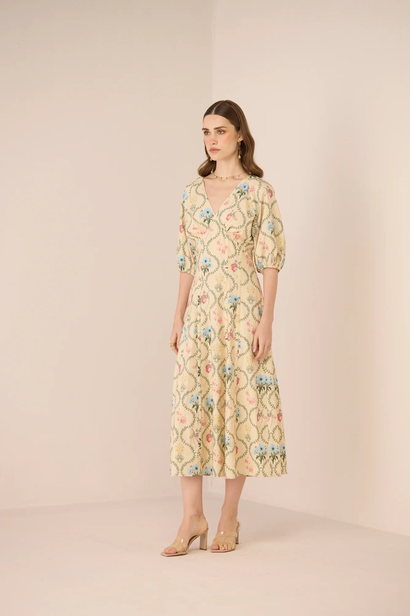 Side view of the Rosewood Midi Dress, showing the botanical print, V neckline, and flowing cotton midi skirt.
