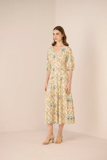 Side view of the Rosewood Midi Dress, showing the botanical print, V neckline, and flowing cotton midi skirt.