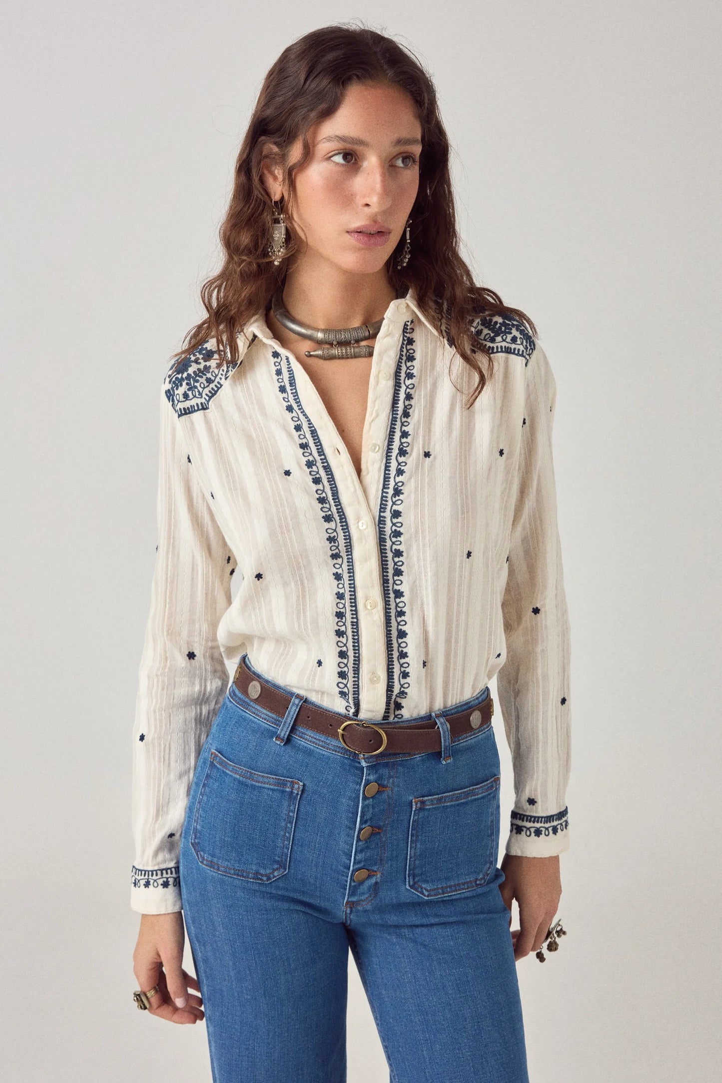 Model wearing the Salinger Shirt in Cream Indigo featuring navy floral embroidery, classic collar, button-down front, and lightweight cotton dobby fabric.