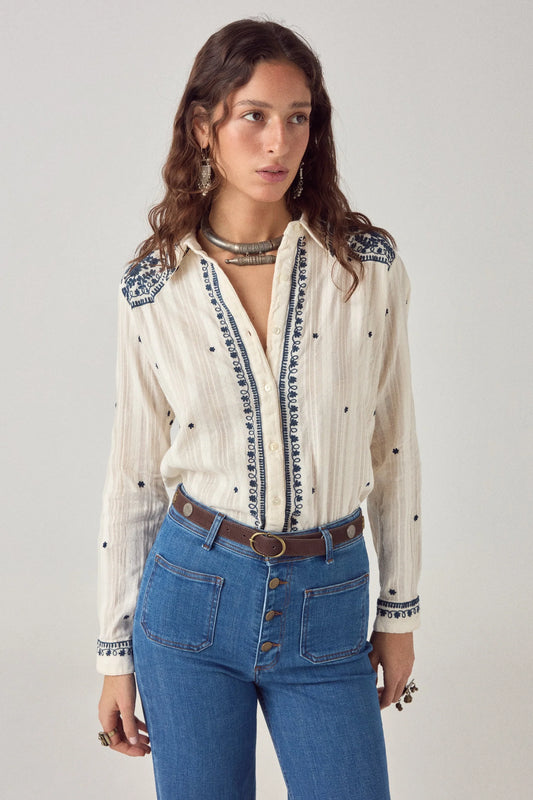 Model wearing the Salinger Shirt in Cream Indigo featuring navy floral embroidery, classic collar, button-down front, and lightweight cotton dobby fabric.