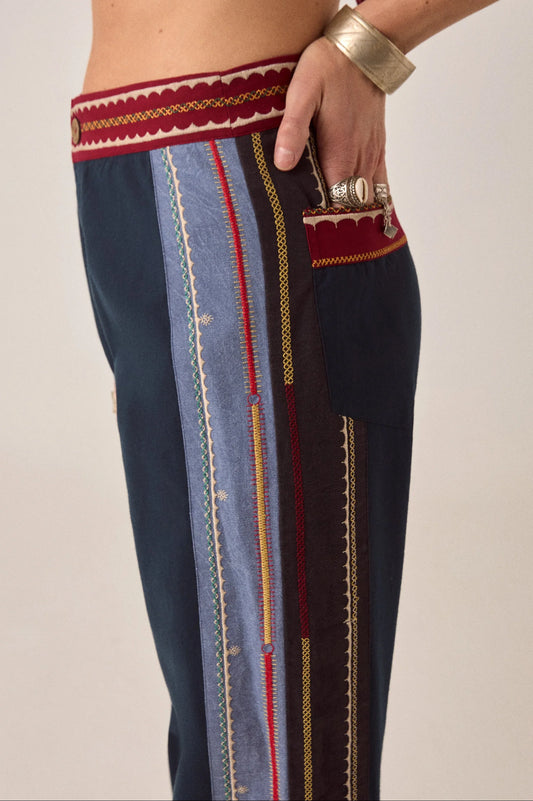 Close-up of Samarkand Brahma Pants in Midnight Patch highlighting embroidered side panels, pocket detail, and woven waistband