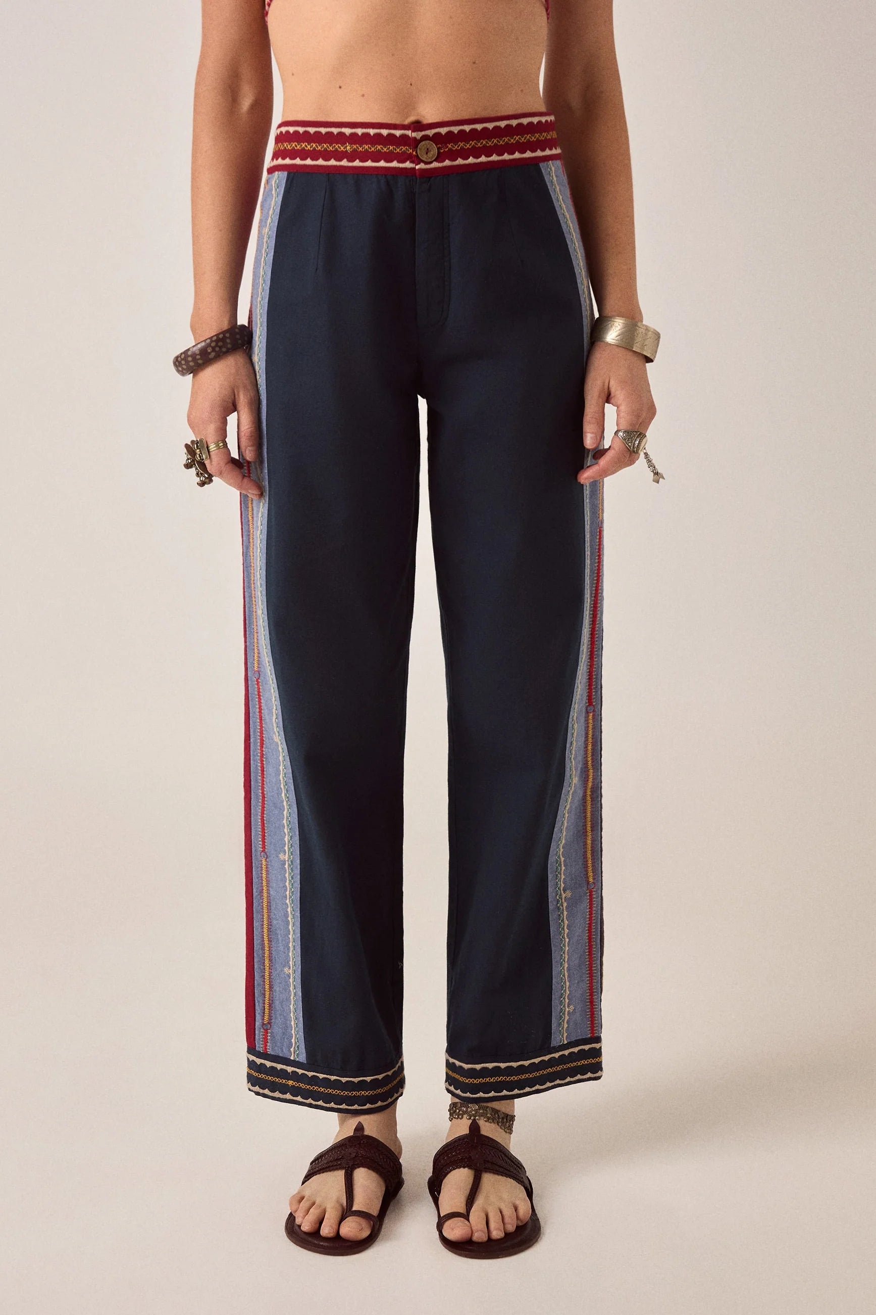 Front view of Samarkand Brahma Pants in Midnight Patch with decorative woven waistband and embroidered side panels