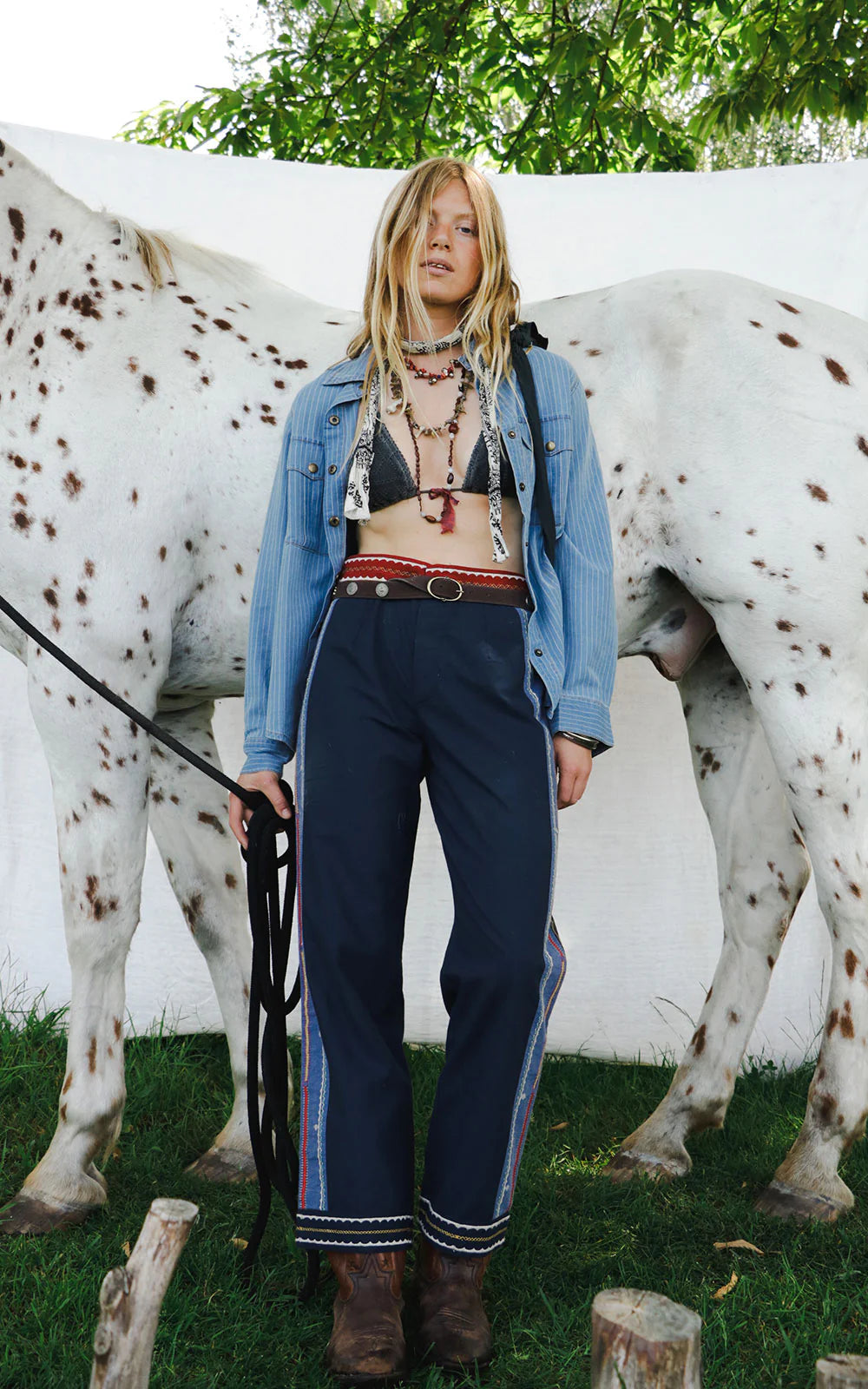 Model wearing Samarkand Brahma Pants in Midnight Patch featuring embroidered side detailing and a woven waistband in a bohemian-inspired styling shot