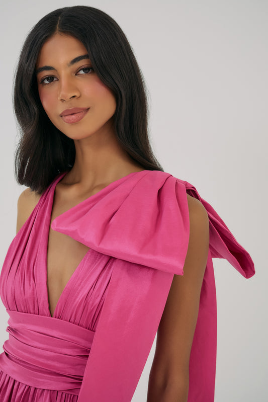 Model wearing Selba Gown in Fuchsia with draped bodice and asymmetrical shoulder tie detail