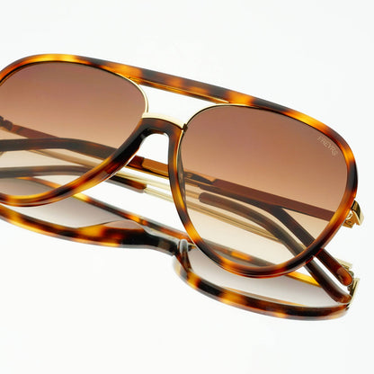 Shay Unisex Aviator Sunglasses in tortoise with gradient brown lenses, shown folded from an angled view.