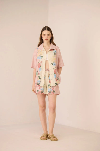Full-length view of the Shea Shorts styled as a matching floral resort set with the Shea Shirt.