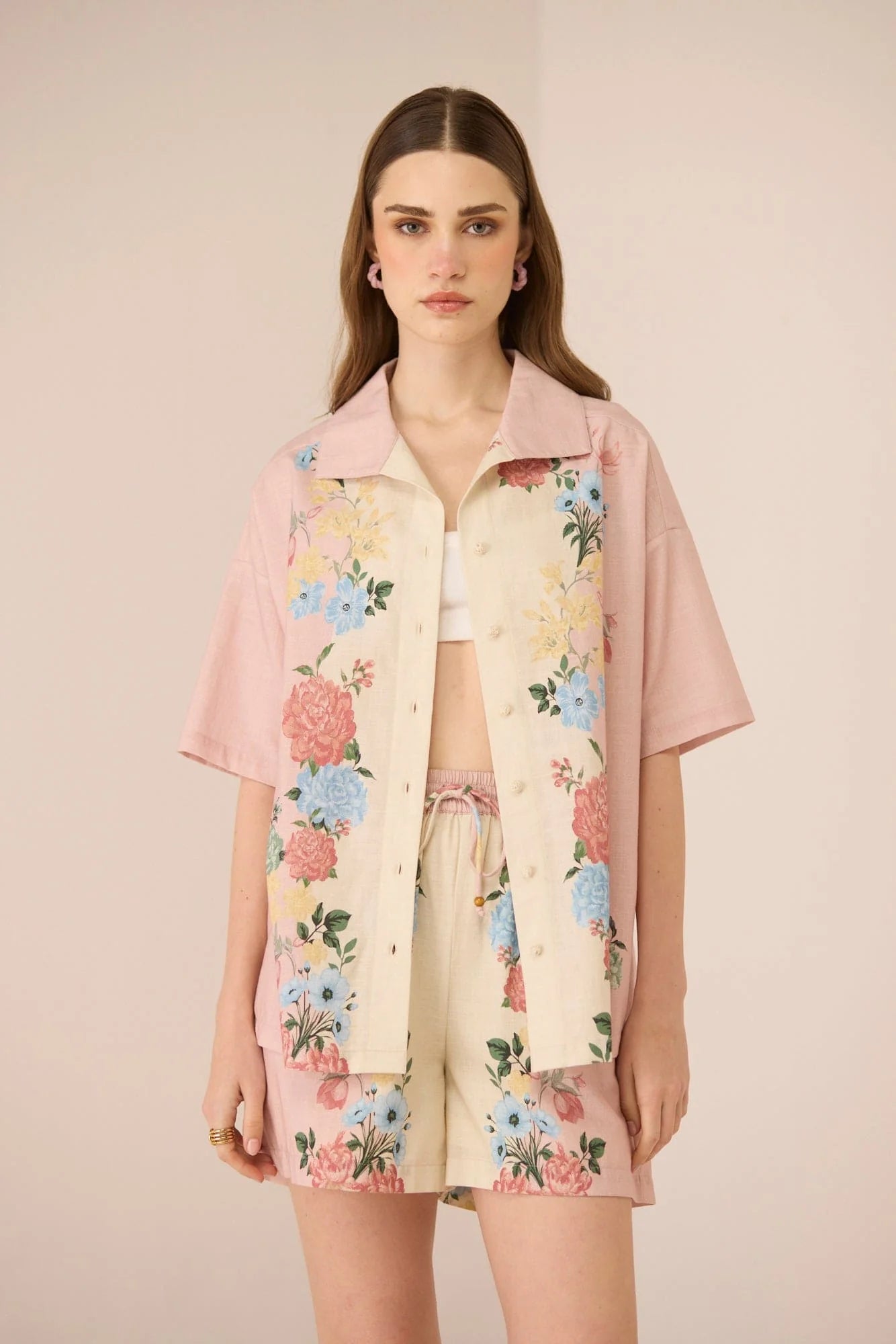 Front view of the Shea Shorts featuring a blush and cream floral print, elastic waistband, drawstring, and side pockets.