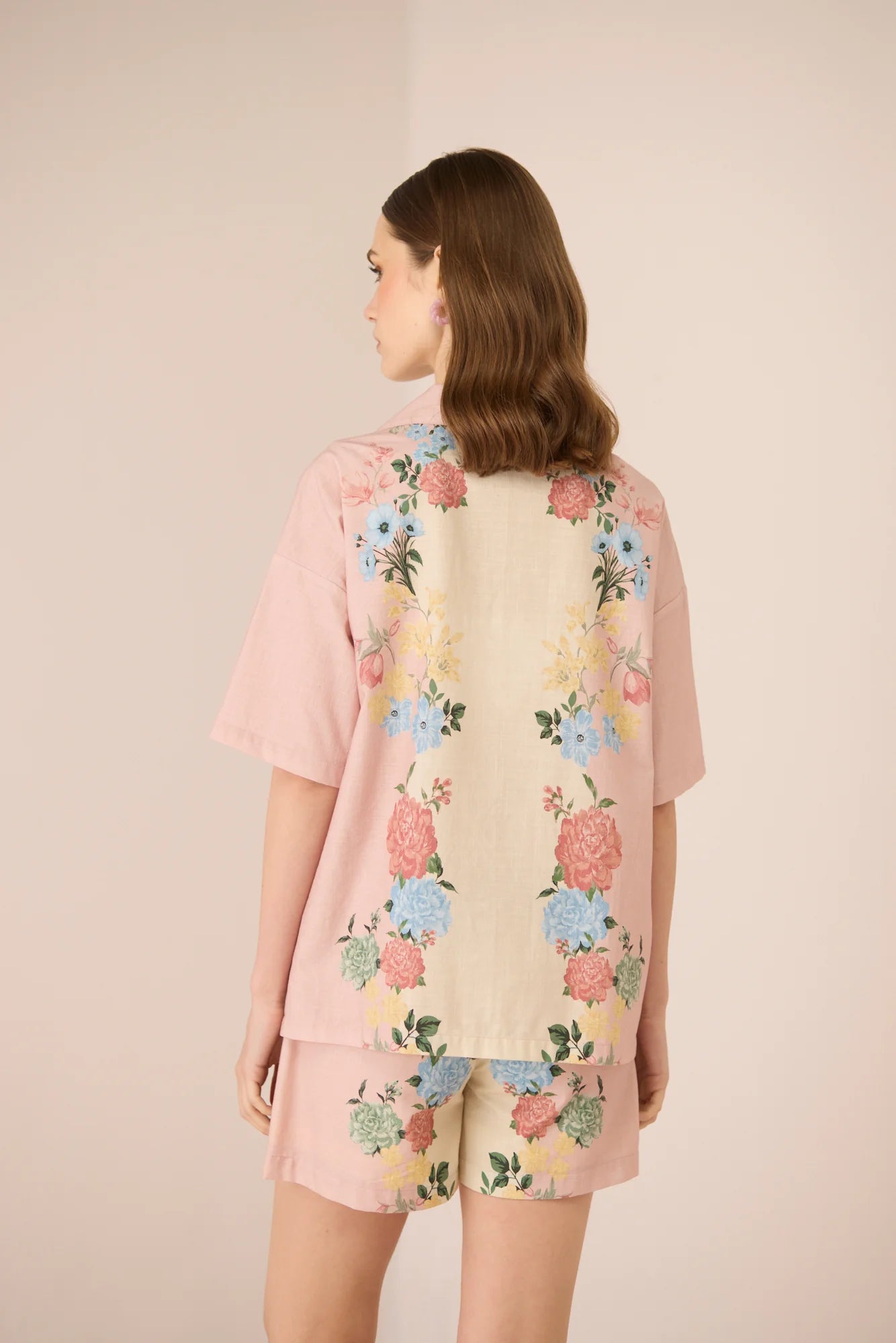 Back view of the Shea Top featuring a blush and cream pastel floral placement print with an easy oversized fit.