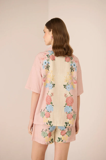 Back view of the Shea Top featuring a blush and cream pastel floral placement print with an easy oversized fit.