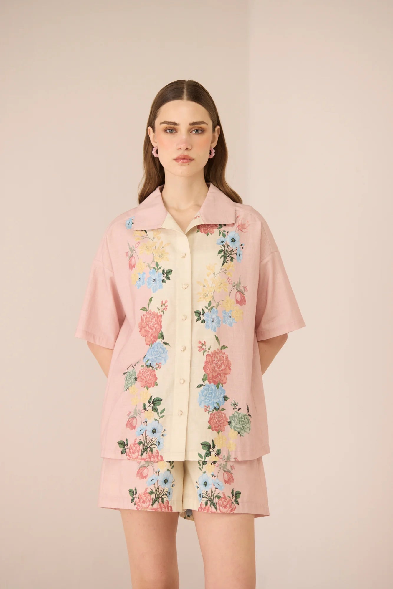 Front view of the Shea Top in a relaxed oversized silhouette with pastel floral placement print and crochet button details.