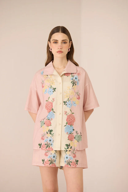 Front view of the Shea Top in a relaxed oversized silhouette with pastel floral placement print and crochet button details.