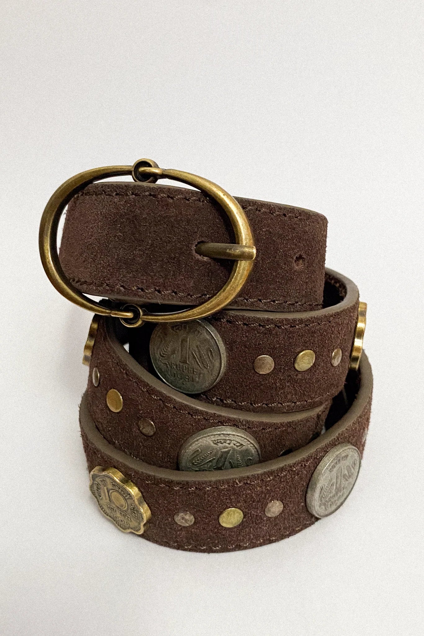 Sikka Belt in Tobacco crafted from brown suede leather with mixed gold and silver coin accents and an antique brass oval buckle.