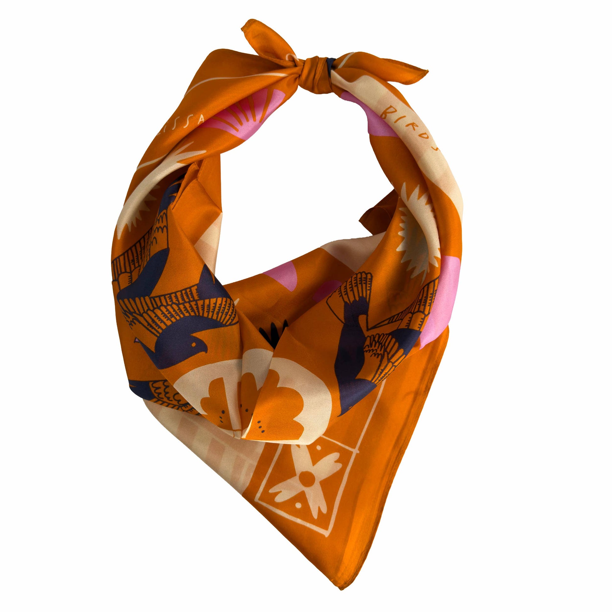 Soar & Sing silk scarf tied in a classic bandana style, showing the warm orange illustrated pattern and lightweight drape.