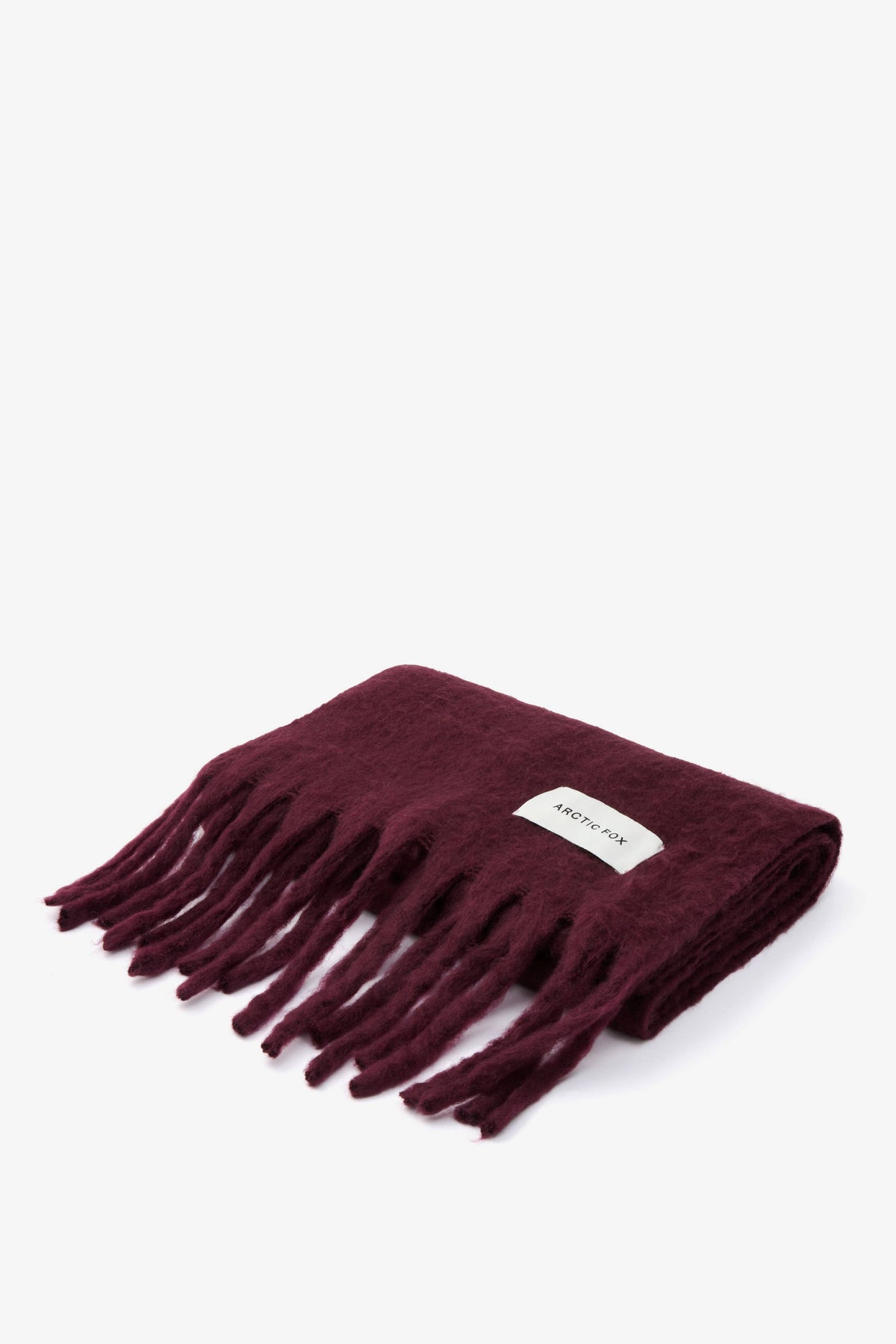 Folded Stockholm Scarf in Cherry Lacquer showing its soft brushed texture and fringe