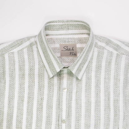 Close-up of the Striped Linen Shirt featuring a classic collar, mother-of-pearl buttons, and sage green vertical stripes.