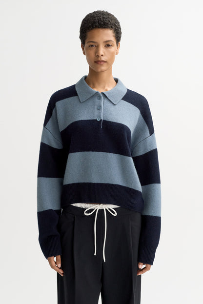 Front view of the Striped Polo Shirt in Retro Blue with bold horizontal stripes, cropped fit, and relaxed long sleeves in luxurious chunky cashmere knit.