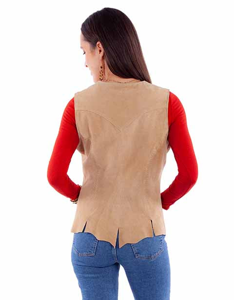 Model wearing a tan suede concho button vest with antique silver buttons, layered over a red long sleeve top and blue jeans.
