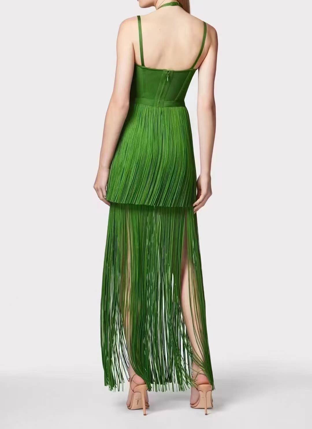 Rear full-length view of the Sultry Green Fringe Halter Maxi Dress showcasing fluid fringe movement and elegant fitted back design.
