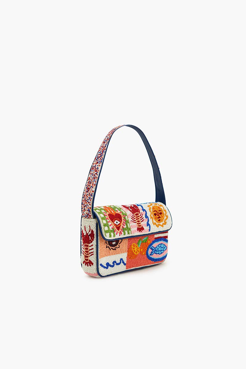 Angled front view of the Sun & Sea Beaded Shoulder Bag featuring colorful beaded artwork, navy blue trim, and shoulder strap.
