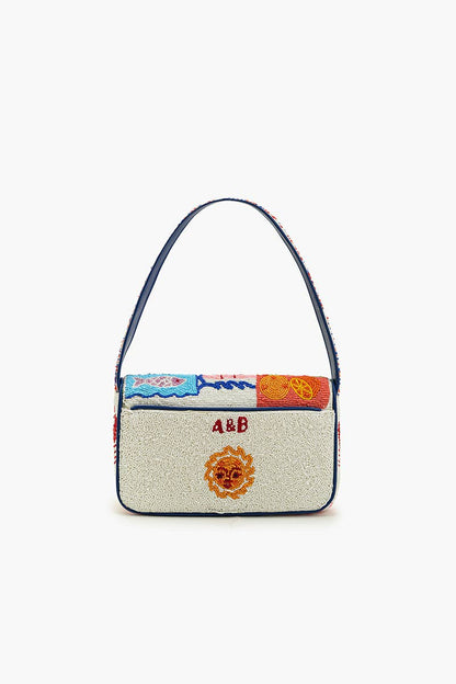 Back view of the Sun & Sea Beaded Shoulder Bag with navy blue binding, structured shape, and hidden magnetic back pocket.