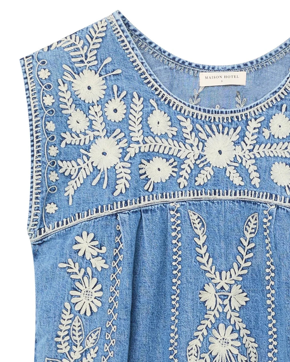 Close-up detail of the Sylvie Arizona embroidered denim mini dress in Blue Haze featuring white floral embroidery and round neckline