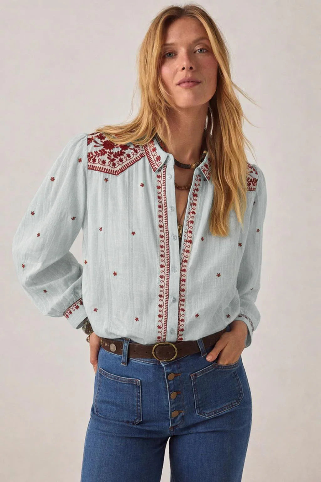 Model wearing the Texas Sun Salinger Shirt in Blue Paprika, showcasing burgundy embroidered detailing, classic collar, button-front closure, and relaxed long-sleeve silhouette.