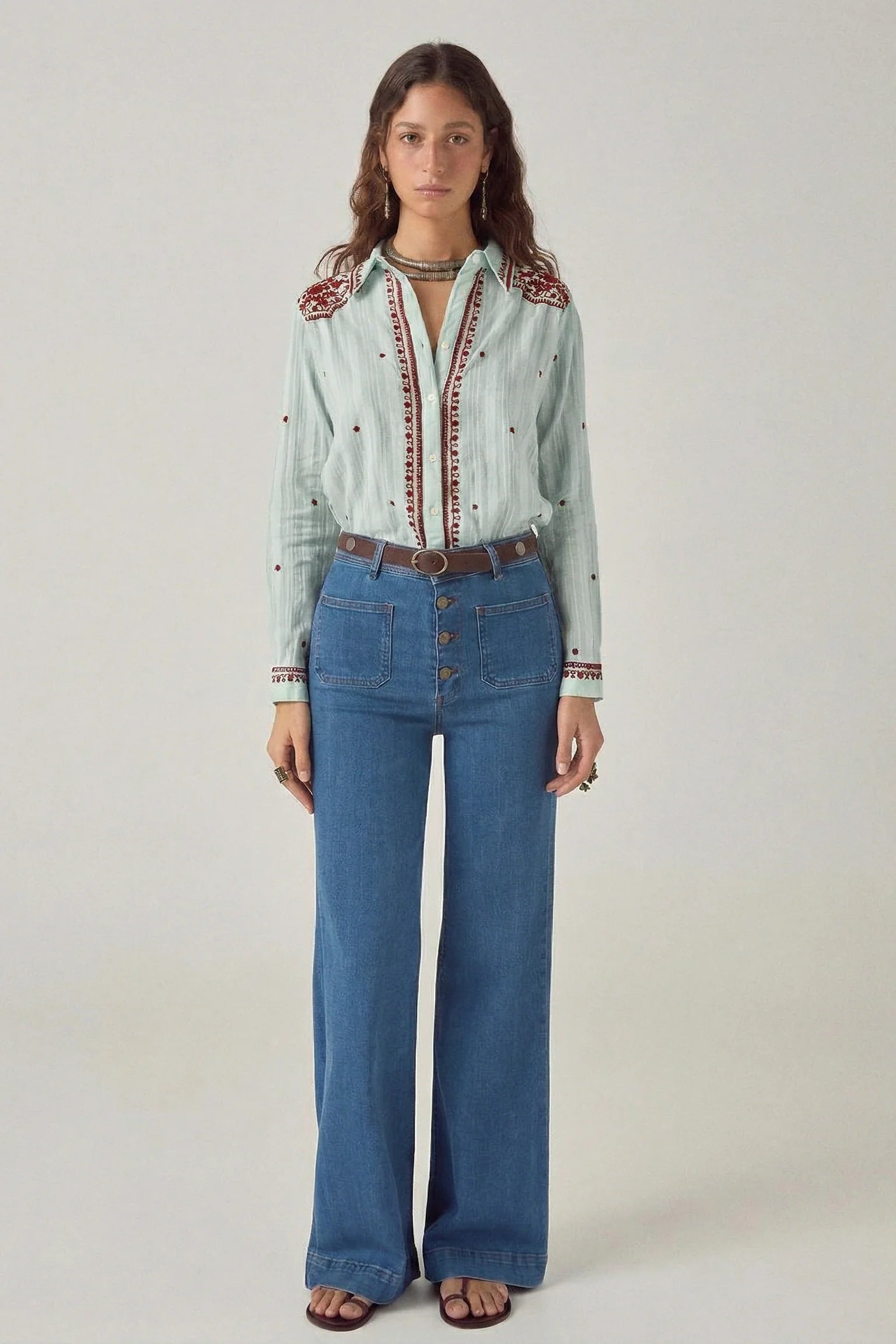Full-length view of the Texas Sun Salinger Shirt in Blue Paprika styled with wide-leg denim, highlighting the relaxed fit, embroidered placket, and Western-inspired bohemian detailing.