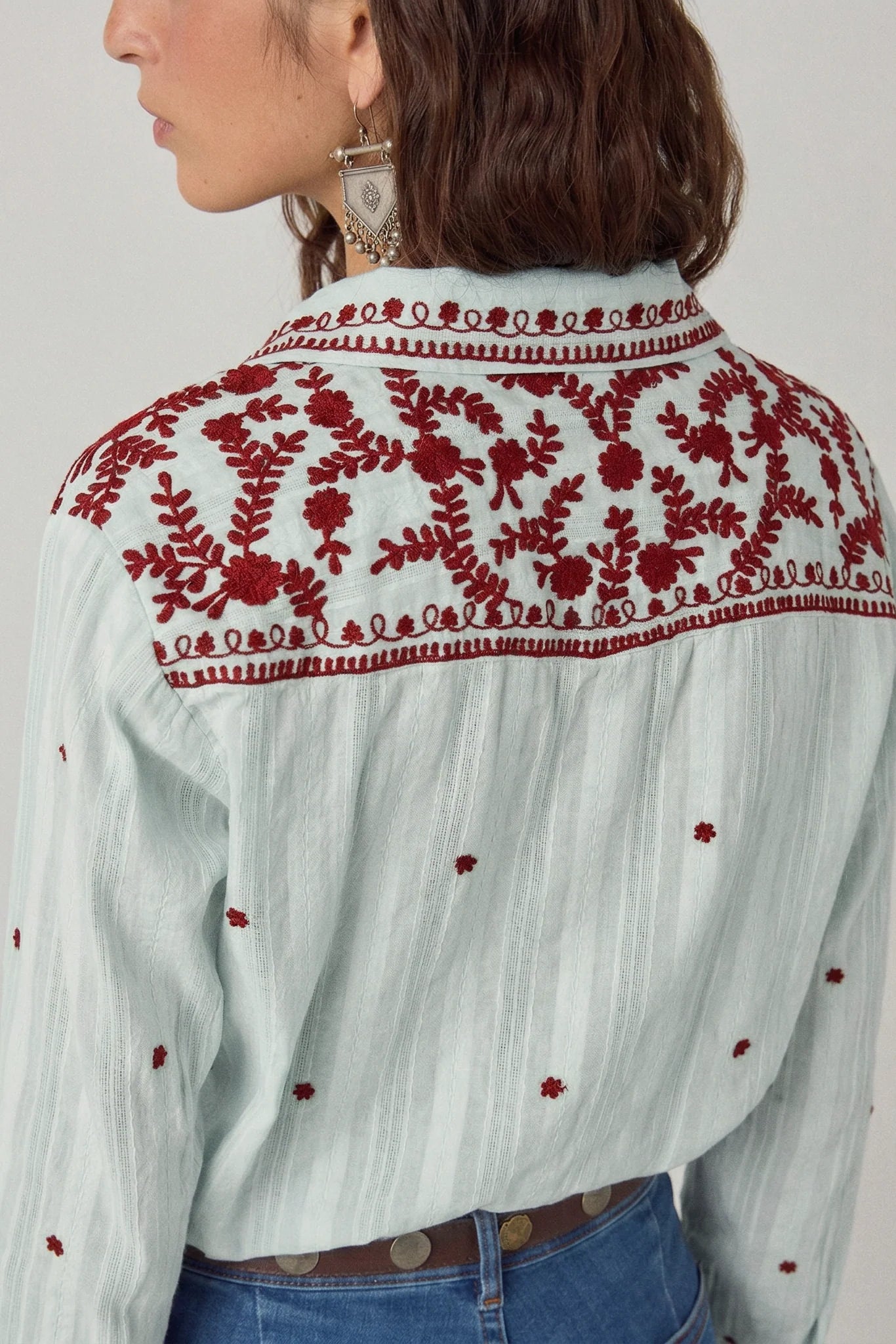 Back view of the Texas Sun Salinger Shirt in Blue Paprika featuring intricate burgundy floral embroidery across the shoulder yoke and scattered embroidered motifs on soft striped cotton.