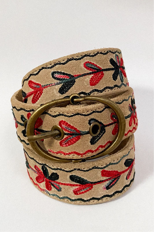 Rolled view of the Thar Belt - Karma Thread highlighting the brass buckle, desert suede leather, and black and red embroidery.