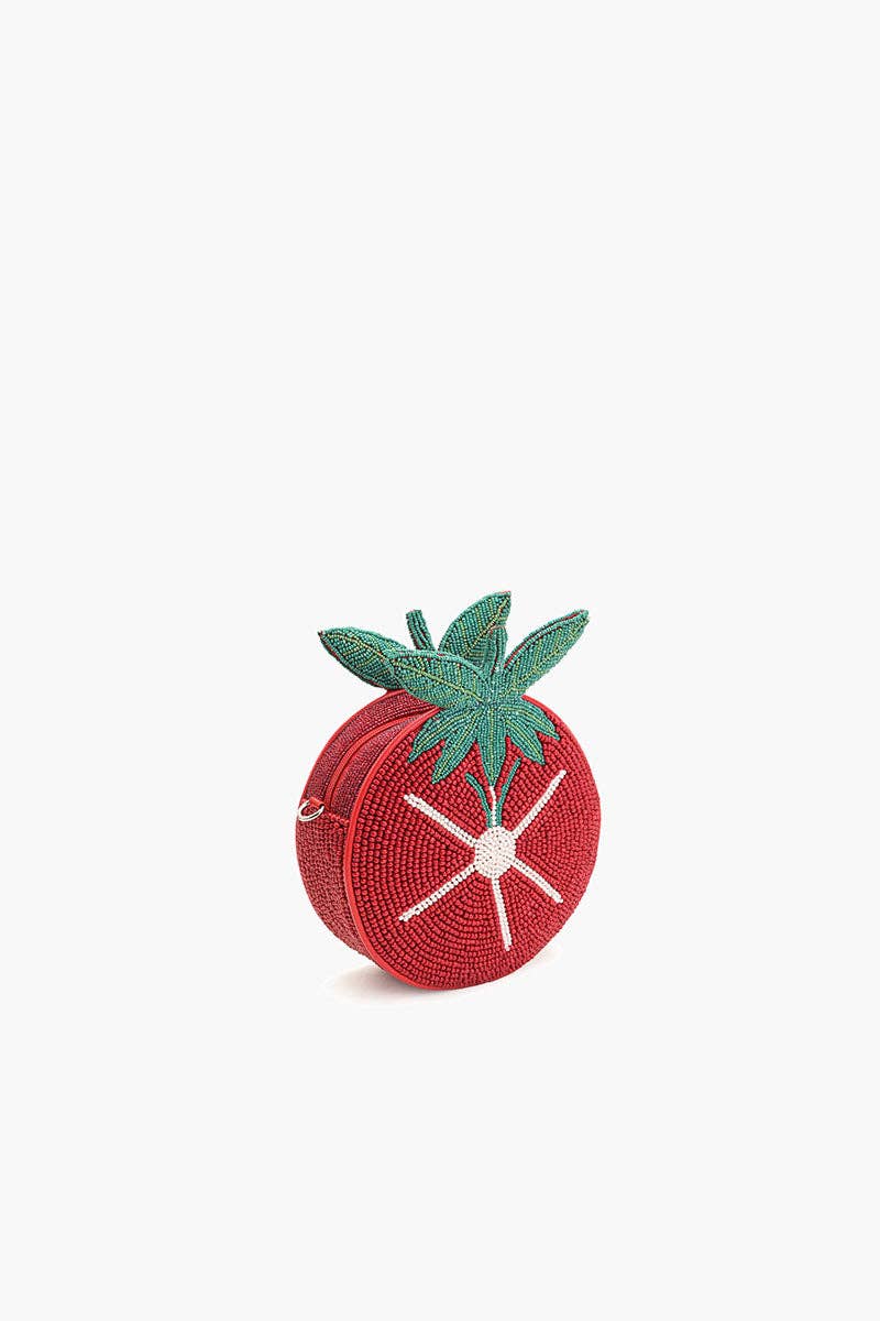 Tomato-shaped red beaded crossbody bag with green leaf top and white starburst bead detail on a white background.
