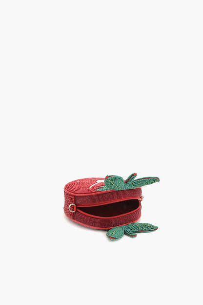 Open top view of the Tomato Tango Crossbody Bag showing the red satin lining, zipper closure, and green beaded leaf accents.
