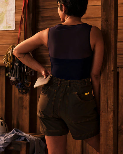 Back view of Trail Tank in Woad worn outdoors showing breathable mesh back panel