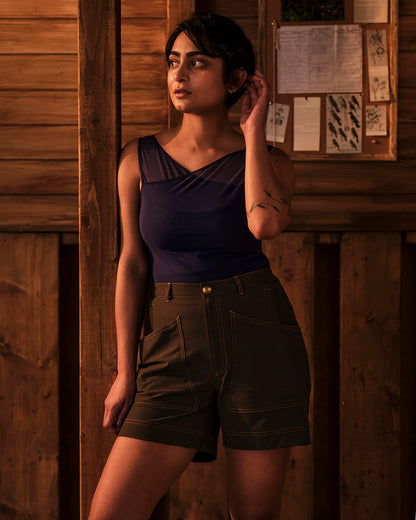 Model wearing Trail Tank in Woad styled with trail shorts in outdoor setting
