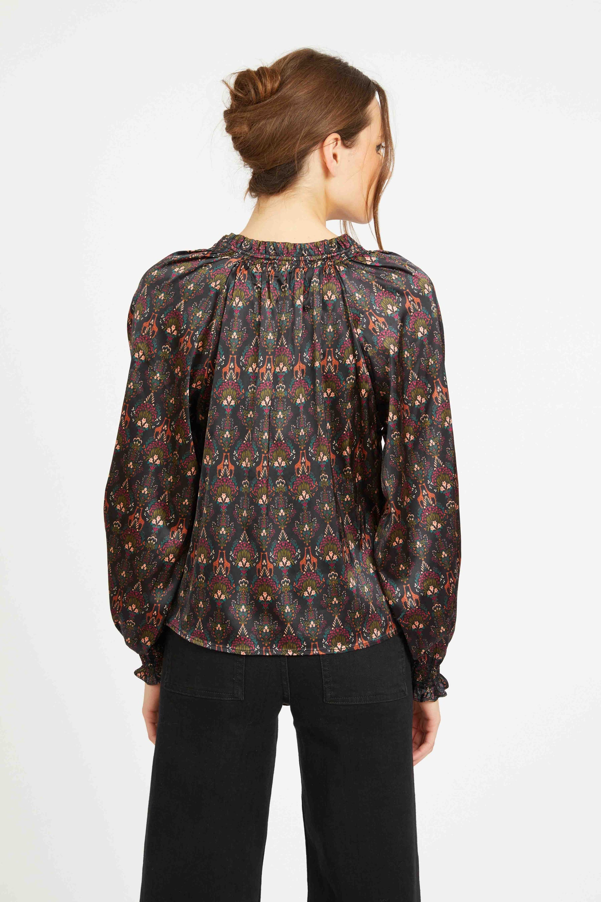 Back view of the Vickie Top featuring a gathered neckline, flowing satin silhouette, and all-over medallion-inspired bohemian print.