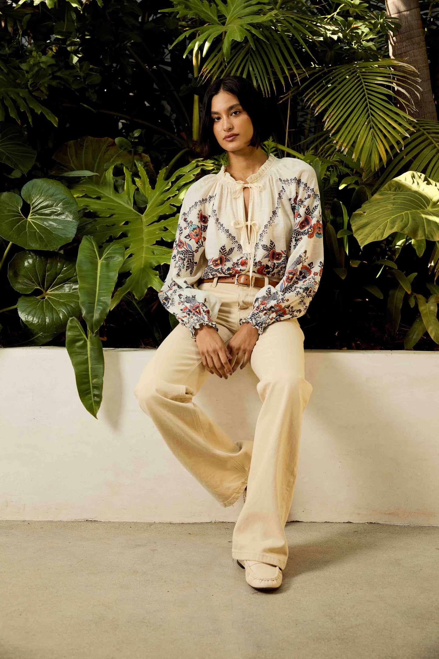 Full-length resort styling of the Vickie Top in Zebra Leaf paired with cream wide-leg pants, showcasing the embroidered floral design and breezy bohemian silhouette.