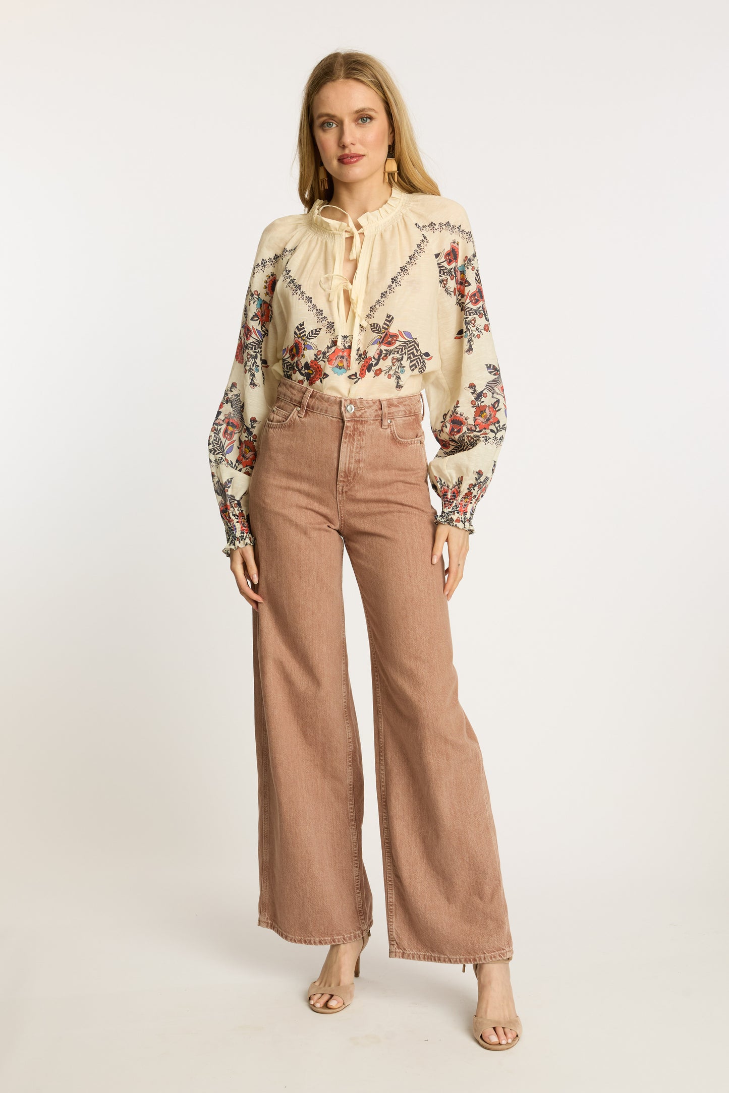 Full front styling view of the Vickie Top in Zebra Leaf paired with blush wide-leg denim, featuring colorful embroidery, tassel tie accents, and bohemian-inspired sleeves.