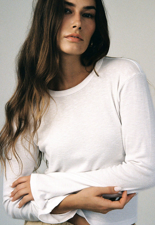 Close-up of model wearing the white Vintage Slub Long Sleeve showing the relaxed fit and flared sleeves