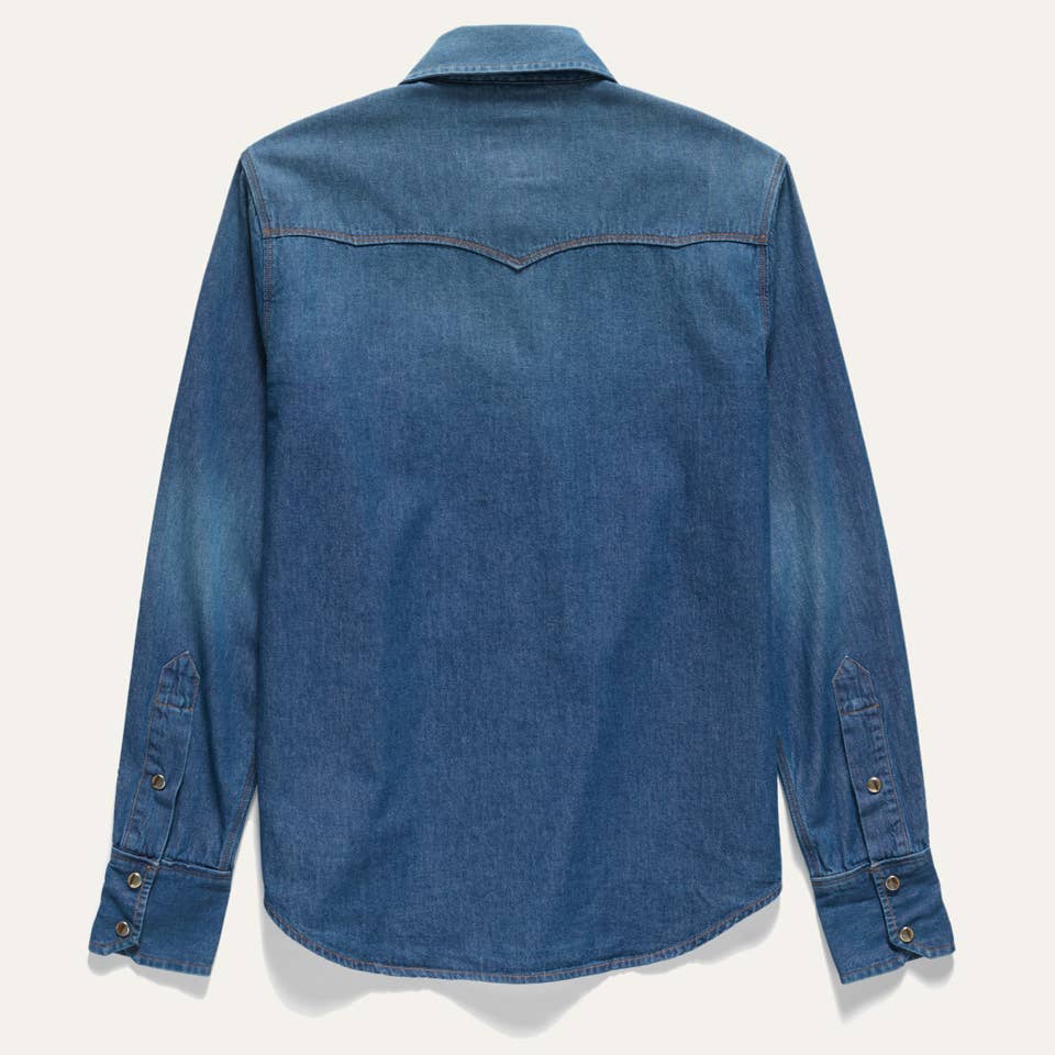 Back view of the Western Snap Shirt in Washed Chambray featuring a classic Western yoke, faded blue chambray fabric, and snap cuff detailing.